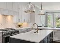 Modern kitchen featuring a large center island, quartz countertops, and stainless steel appliances at 1032 Spyglass Ln, Waxhaw, NC 28173