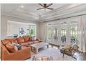 Relaxing living room with a tray ceiling, ceiling fan, and oversized seating area at 1032 Spyglass Ln, Waxhaw, NC 28173