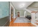 Elegant foyer with hardwood floors, staircase, modern lighting, and open doorway showcasing the home's layout at 119 Foote St, Chester, SC 29706