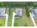 This aerial shot highlights a home with well-manicured lawns and proximity to a neighborhood at 11922 Kimberfield Rd, Matthews, NC 28105
