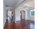 Dining room with tray ceiling, elegant chandelier, chair rail, and wood floors offer a bright space at 11922 Kimberfield Rd, Matthews, NC 28105