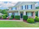 Charming home entrance with manicured hedges, stone accents, and a welcoming front door at 11922 Kimberfield Rd, Matthews, NC 28105