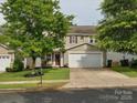 Inviting two-story home with a well-kept lawn and an attached two-car garage at 13314 Pontchatrain Ave, Charlotte, NC 28273