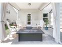 Relaxing covered patio with comfortable seating and a view of the backyard at 171 Old Harbor Dr, Mount Gilead, NC 27306