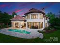 Beautiful backyard with a pristine pool and a curved wall of windows offering panoramic views at 173 Rehoboth Ln, Mooresville, NC 28117