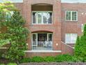 This balcony has white metal railings overlooking a green landscaped area, offering an inviting outdoor space at 1903 Kenilworth Ave # 104A, Charlotte, NC 28203