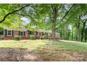 Traditional brick home with shade trees, level lawn, and manicured shrubs at 1925 Montclair Ave, Gastonia, NC 28054