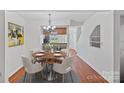 Inviting dining area with a modern chandelier and hardwood floors with a round table at 218 Water Oak Dr, Pineville, NC 28134