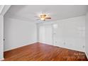 Bright living room features hardwood floors, ceiling fan, and access to a sliding glass door at 218 Water Oak Dr, Pineville, NC 28134