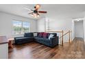 Bright living room featuring a large window, cozy sectional sofa, and modern ceiling fan with lighting at 23 Redwood Ct, Alexander, NC 28601