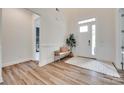 Bright foyer with hardwood floors, wainscoting, and a bench beneath a transom window at 2324 Loire Valley Dr, Indian Land, SC 29707