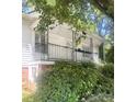 Charming front porch with decorative iron railing, white siding, and well-maintained landscaping at 237 Institute St, Mooresville, NC 28115