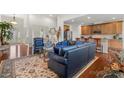 Open-concept living room with hardwood floors and comfortable seating, perfect for entertaining at 2399 Ashbourne Se Pl, Concord, NC 28025
