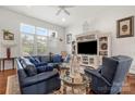 Spacious living room featuring neutral paint, large windows, and plush seating at 2399 Ashbourne Se Pl, Concord, NC 28025