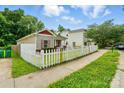 View of the home with white picket fence along the side of the lawn at 2723 Craddock Ave, Charlotte, NC 28208