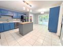 Bright eat-in kitchen featuring blue cabinetry, stainless steel appliances, and tile floors at 3051 Dairy Farm Dr, Monroe, NC 28110