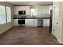 Modern kitchen with stainless steel appliances, granite countertops, and white cabinets at 307 Wilson St, Monroe, NC 28112
