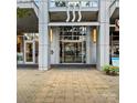 Modern building entrance with glass doors, striking architectural details, and well-maintained landscaping at 333 W Trade St # 1106, Charlotte, NC 28202