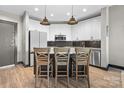 Well-appointed kitchen featuring white cabinetry, a central island with seating, and stainless steel appliances at 333 W Trade St # 1106, Charlotte, NC 28202
