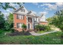 Beautiful two-story home with brick accents, lush landscaping, and a welcoming entrance at 3500 Cedar Springs Sw Dr, Concord, NC 28027