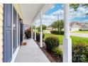 View of the front porch with a cozy chair, neat landscaping, and neighborhood view at 4469 Greystone Sw Dr, Concord, NC 28027