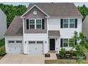 Charming two-story home with a two-car garage, nicely landscaped yard, and lovely curb appeal at 5121 Arbordale Way, Mount Holly, NC 28120