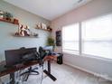Bright office space with lots of light, floating shelves, and sleek computer setup at 5121 Arbordale Way, Mount Holly, NC 28120