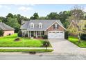 Beautiful brick home with lush lawn, dormer windows, and a two-car garage at 5707 Sustar Dr, Monroe, NC 28110
