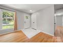 Inviting foyer features hardwood floors, ample natural light, and a front door with charming details at 6215 Cross Creek Ln, Charlotte, NC 28212