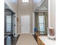Bright foyer with a neutral rug and light walls and views of the study and dining areas at 7700 Antique Cir, Waxhaw, NC 28173