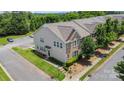 Aerial view of townhomes with manicured lawns and ample parking at 9001 Lanark Ln, Fort Mill, SC 29707