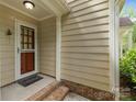 Inviting front porch showcasing brick steps and a charming screen door at 906 Wishing Well Ln, Charlotte, NC 28270