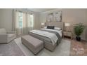 Serene bedroom with neutral tones, soft lighting, and large windows at 1117 Morehead Dr, Salisbury, NC 28144