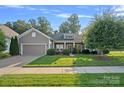 Inviting single-Gathering home with a well-kept lawn, featuring stone accents and a two-car garage at 114 Canoe Pole Ln, Mooresville, NC 28117