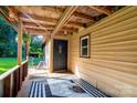 Inviting covered porch features a decorative rug, exterior siding, and a glimpse of the green yard at 121 C And C Ln, Mooresville, NC 28115
