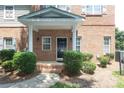 Welcoming front porch with decorative columns and lush landscaping leading to the front door at 12321 Aquitaine St, Charlotte, NC 28277