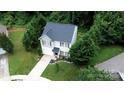 Aerial view of the property showcasing the lush landscaping and surrounding trees at 1548 Logan Patrick Ct, Gastonia, NC 28052