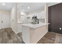 Contemporary kitchen features white cabinets, quartz countertops, and stainless steel appliances at 17136 Red Feather Dr, Charlotte, NC 28277