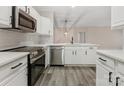 Modern kitchen with stainless steel appliances, white cabinetry, and sleek quartz countertops at 17136 Red Feather Dr, Charlotte, NC 28277