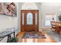 Welcoming foyer with a decorative wooden door, hardwood floors, and a view of the dining area at 172 Hunters Hill Dr, Statesville, NC 28677