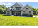 Charming stone-front house with a well-manicured lawn and covered front porch at 174 Bellingshire Dr, Mt Ulla, NC 28125