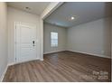 Bright living room featuring wood-look flooring and a front door at 2142 Sunflower Cir, Newton, NC 28658