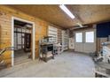 Spacious garage with wood paneling, ample shelving, and potential for workshop or storage at 2500 Kendrick Dr, Charlotte, NC 28214