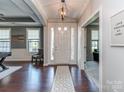 Welcoming foyer featuring hardwood floors, decorative lighting, and an open view to other living spaces at 314 Candella Dr, Matthews, NC 28104