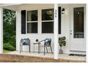 Inviting front porch with seating area, perfect for enjoying a morning coffee at 384 Speedway Pl, Concord, NC 28027