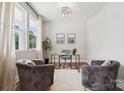Stylish home office with modern furniture and ample natural light from the windows at 384 Speedway Pl, Concord, NC 28027