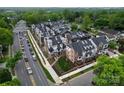 Aerial view of new townhome community with sidewalks and landscaping, close to shops and local businesses at 4121 Selwyn Walk Ct, Charlotte, NC 28209