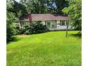 Backyard view showing a lush green lawn with mature trees surrounding the property at 423 Tot Dellinger Rd, Cherryville, NC 28021