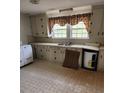 Vintage kitchen with ample cabinet space, a double sink, and a window view to the exterior at 423 Tot Dellinger Rd, Cherryville, NC 28021