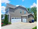 Spacious home featuring a three-car garage and neutral siding at 4386 Oldstone Dr, Harrisburg, NC 28075